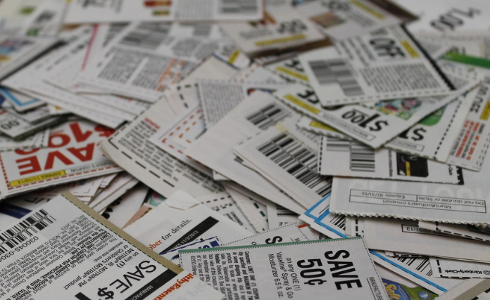 Coupons astrewn, possibly on a kitchen table